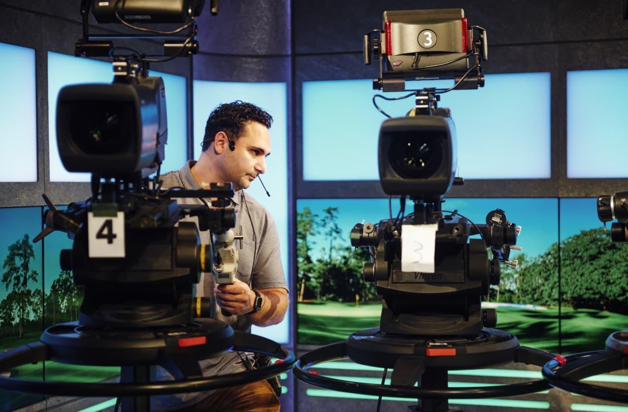 a man operating a studio camera